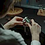 A jeweler uses a caliper to measure with precision in a professional workshop.